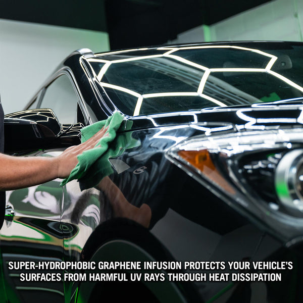 Polishing a sleek, black car. The Turtle Wax graphene ceramic helps achieve a reflective, showroom shine. Detailing for auto enthusiasts.